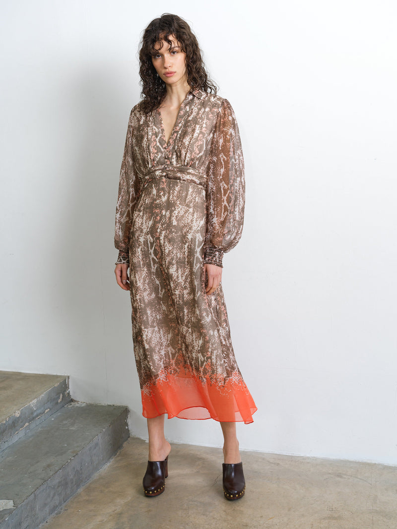 Woman wearing a long sleeve, textured snake print shirt midi dress