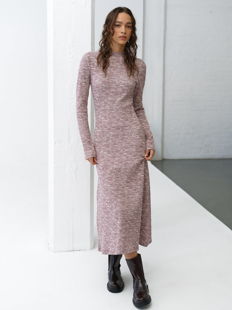 Woman wearing a burgundy and white, long-sleeve ribbed texture midi dress with a flared hem