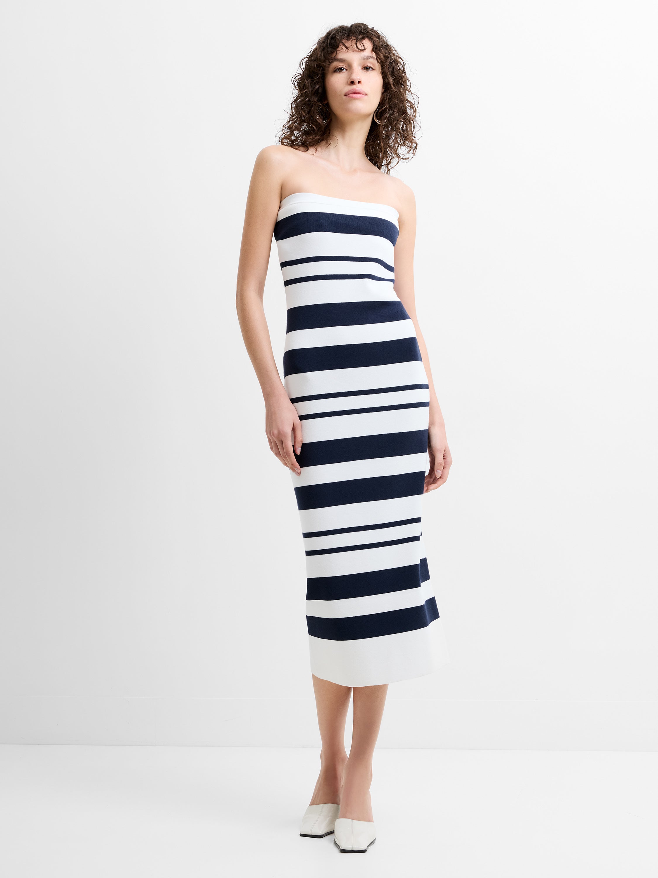 Woman wearing a strapless navy and white striped midi dress