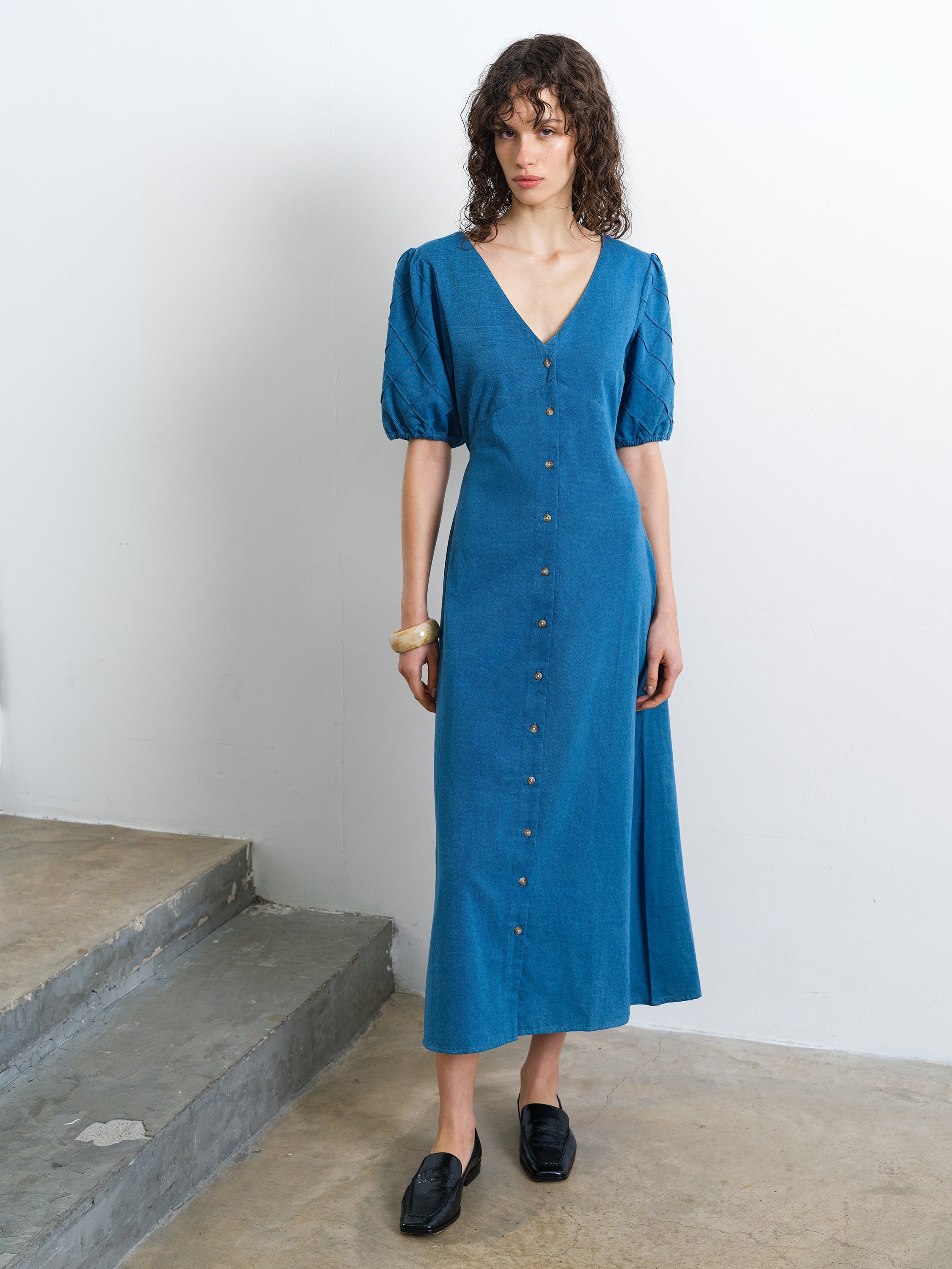 Woman wearing a short sleeve V-neck blue denim midi dress