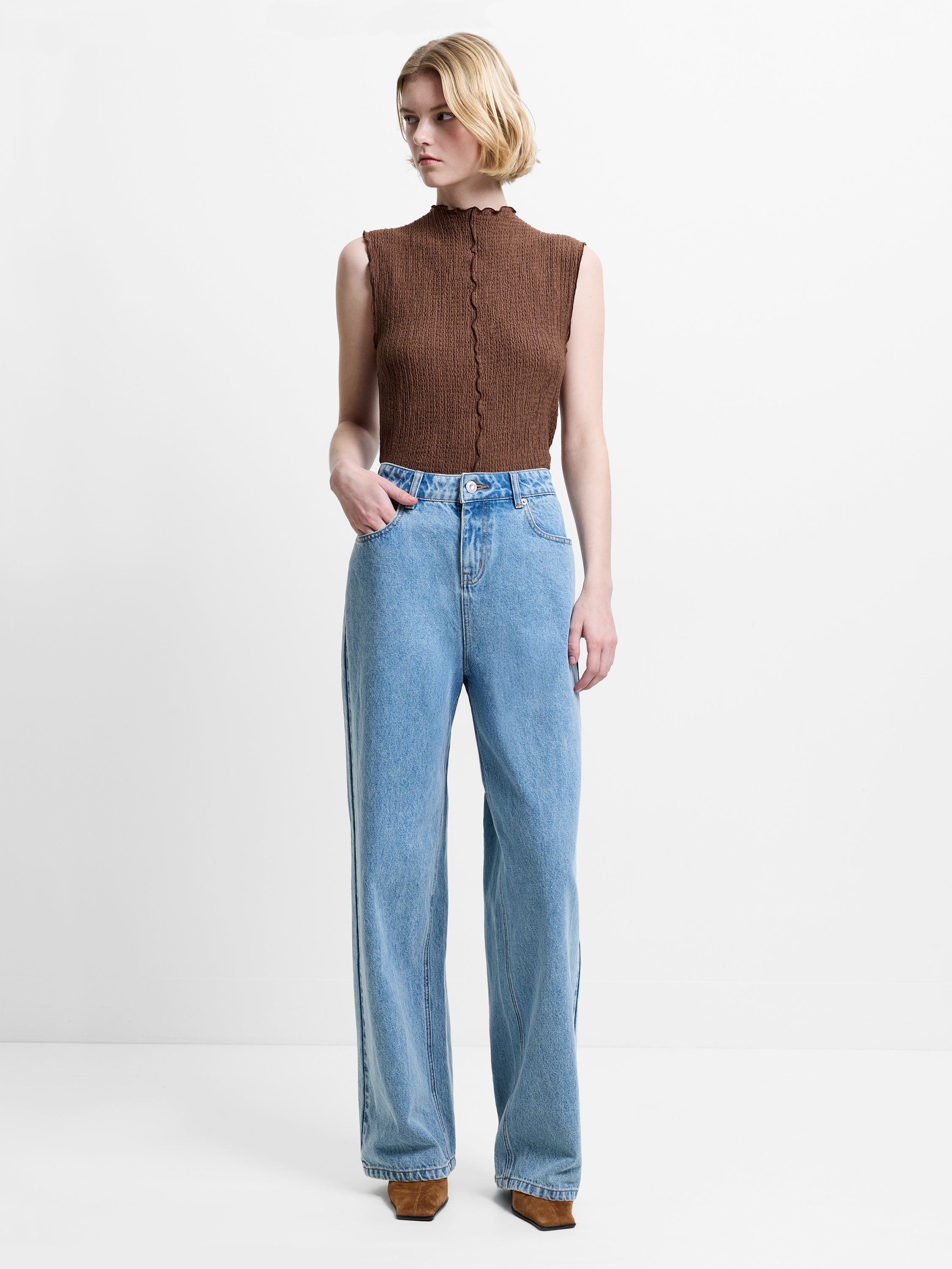 Woman wearing blue denim high waisted boyfriend fit jeans