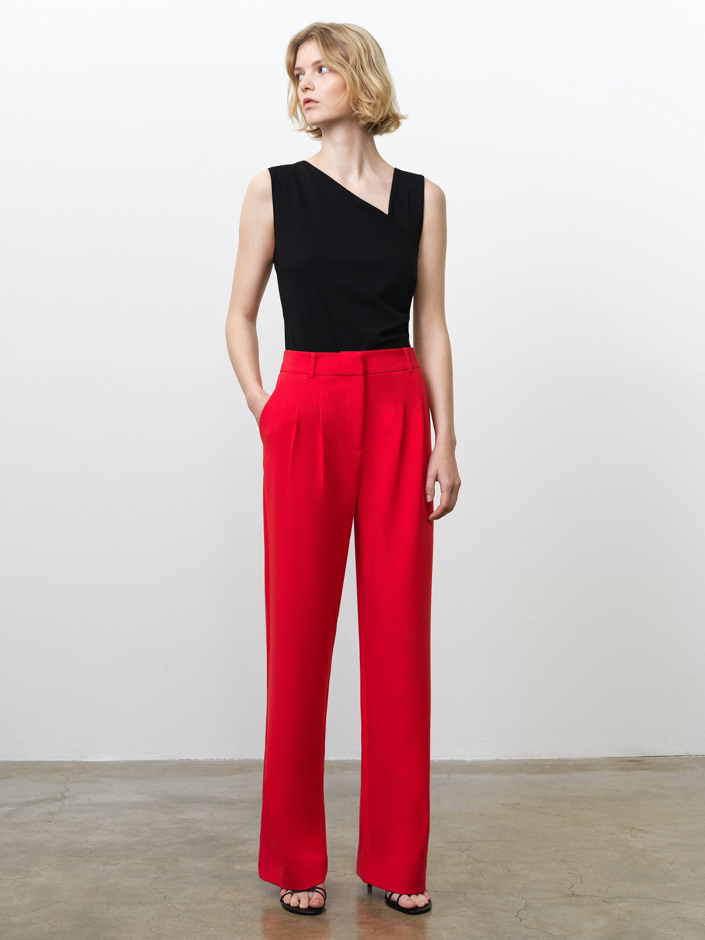 Woman wearing high waisted, wide leg bright red tailored trousers