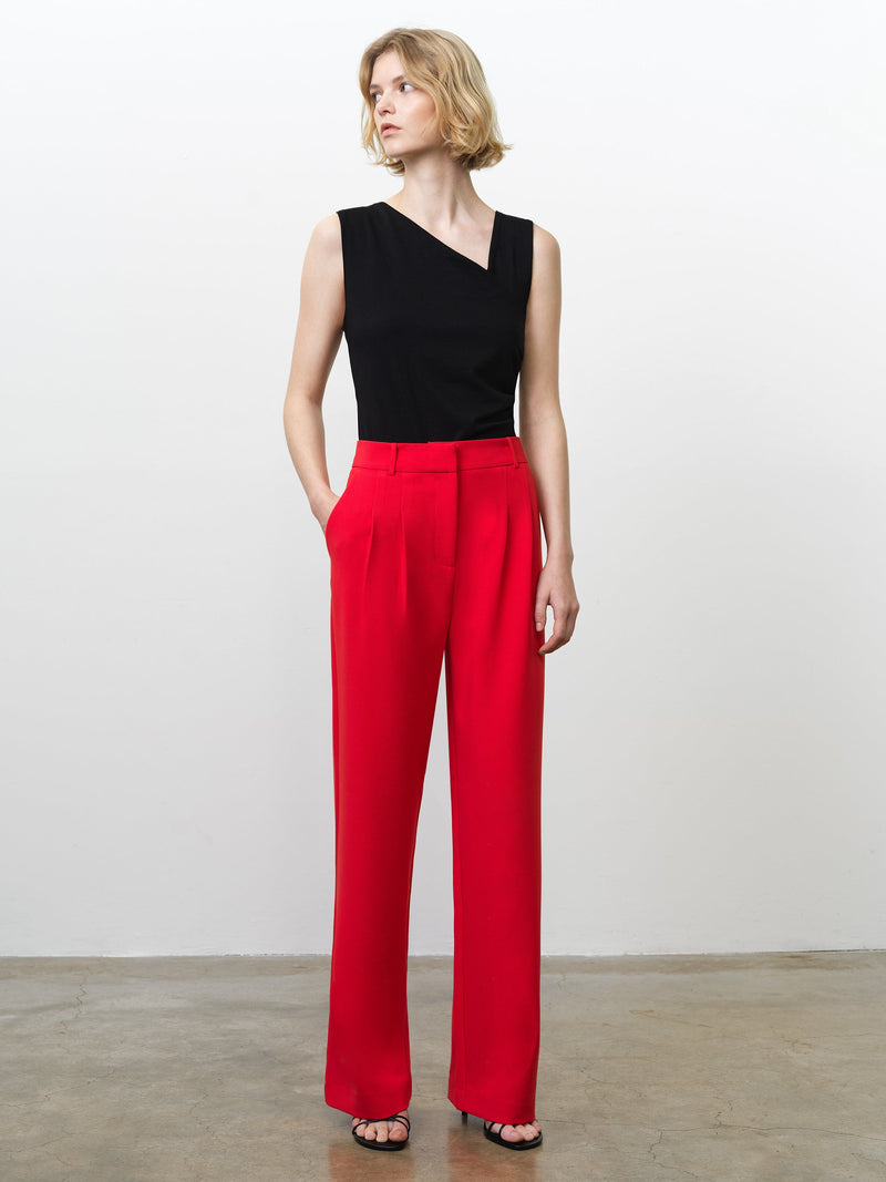 Woman wearing high waisted, wide leg bright red tailored trousers