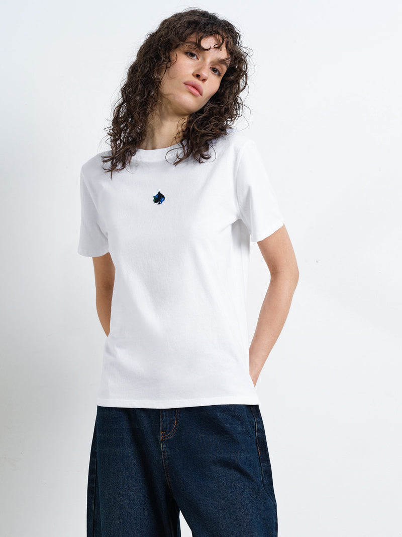 Woman wearing a short sleeve round neck, white T-shirt with an ace of spades and floral back graphic